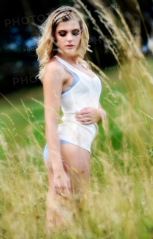 Young woman in lingerie posing outdoors
