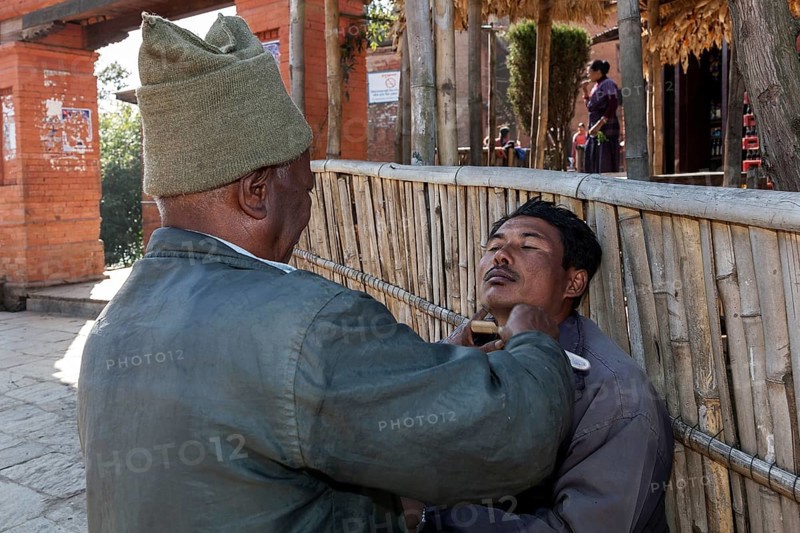 Man being shaved by a barber in Nargakot