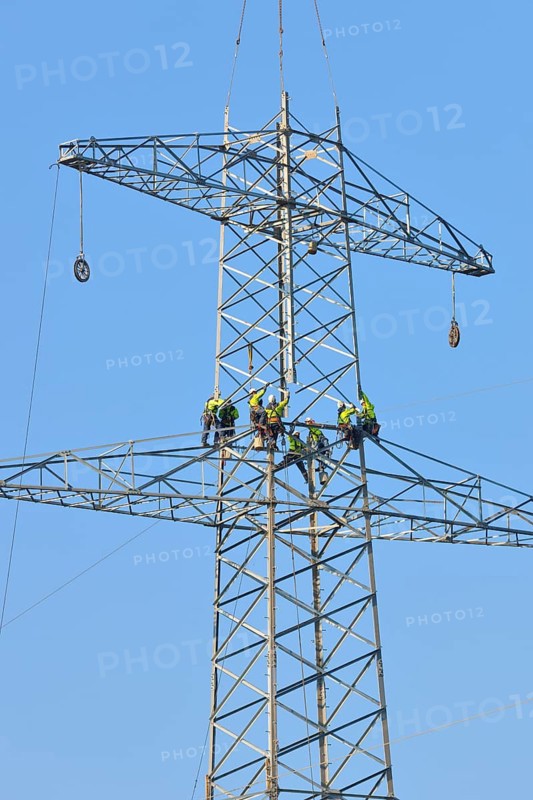 Overhead linemen working on a pylon