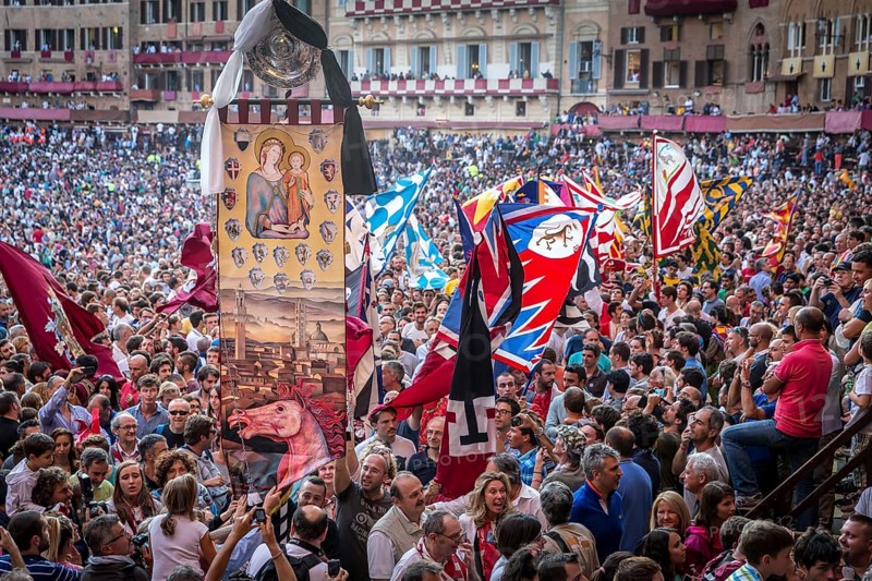 The winning team of the Palio di Siena is awarded a banner of painted silk