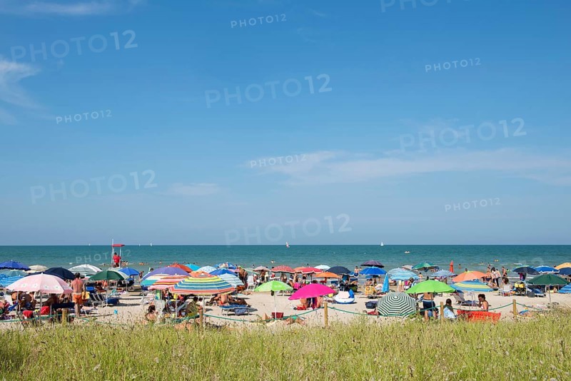 Sea and a sandy beach with sunshades