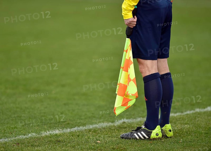 Legs of a linesman with a flag