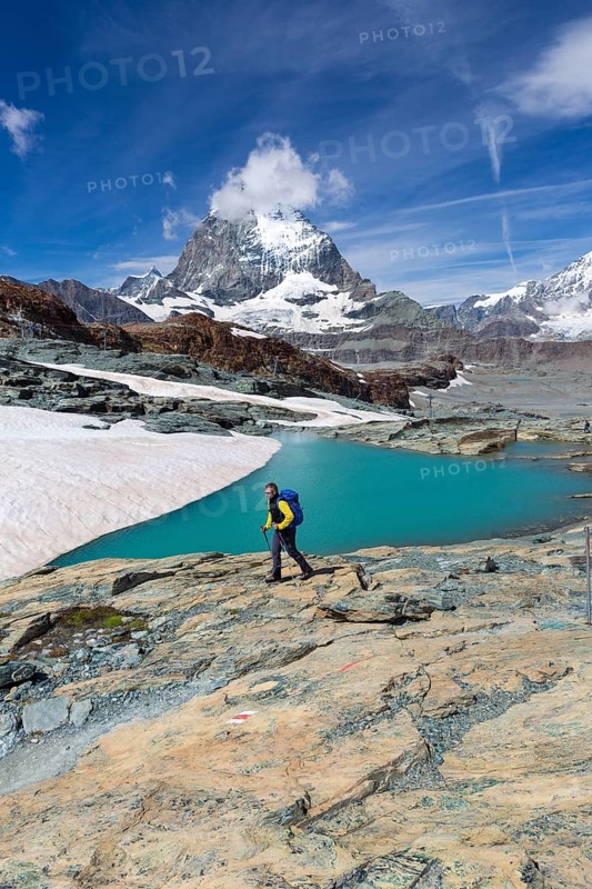 Hiker at glacier lake on the way to the Gandegg hut
