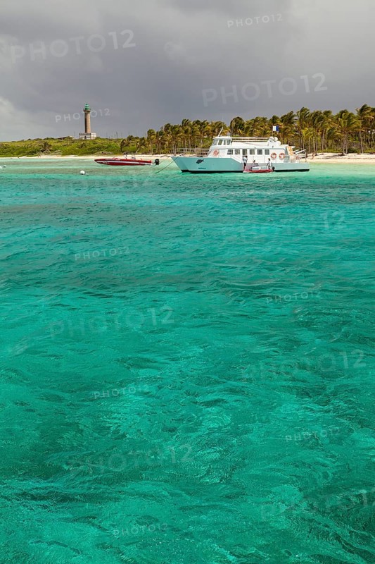Boats off the island with a lighthouse