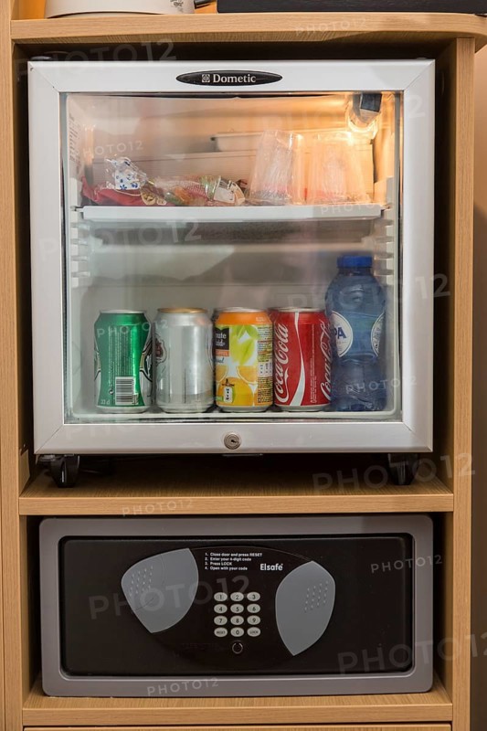 Mini bar with drinks and a safe for valuables in a hotel room