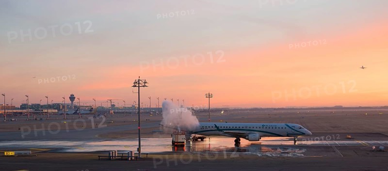 Aircraft de-icing at sunrise
