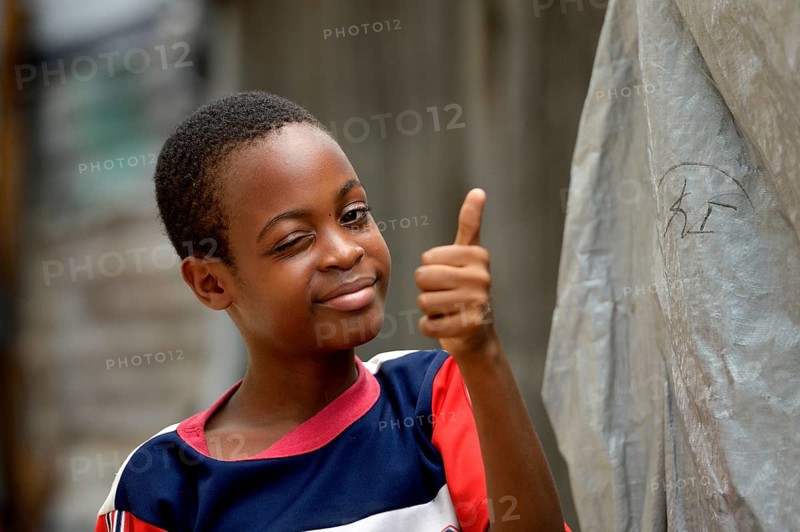 Young winking and giving his thumbs up