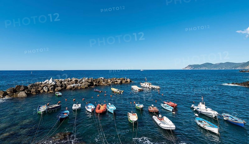 Boats in the harbor in front of harbour protection wall