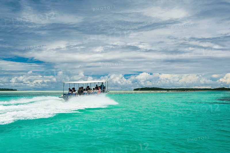 Tourist boat crossing an artificial canal