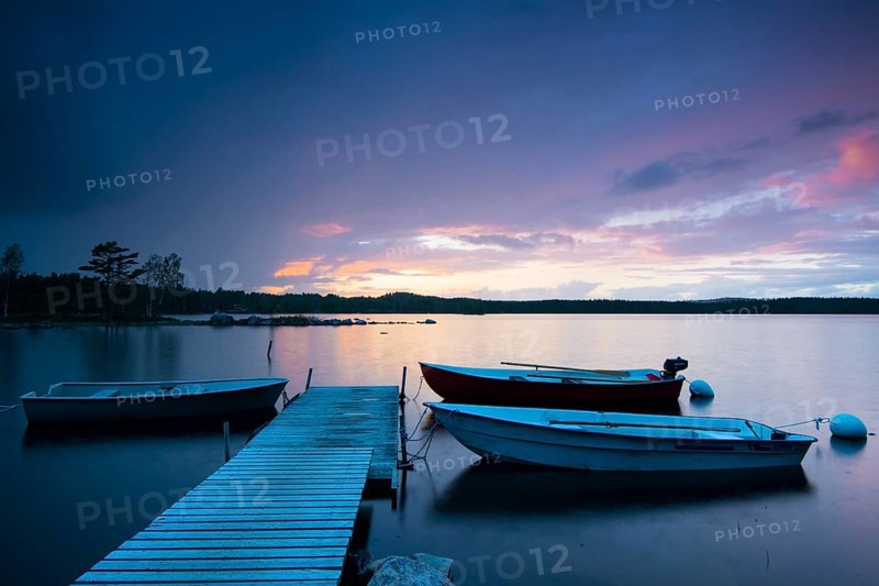 Boats at the jetty at sunset on lake Skarvsjo