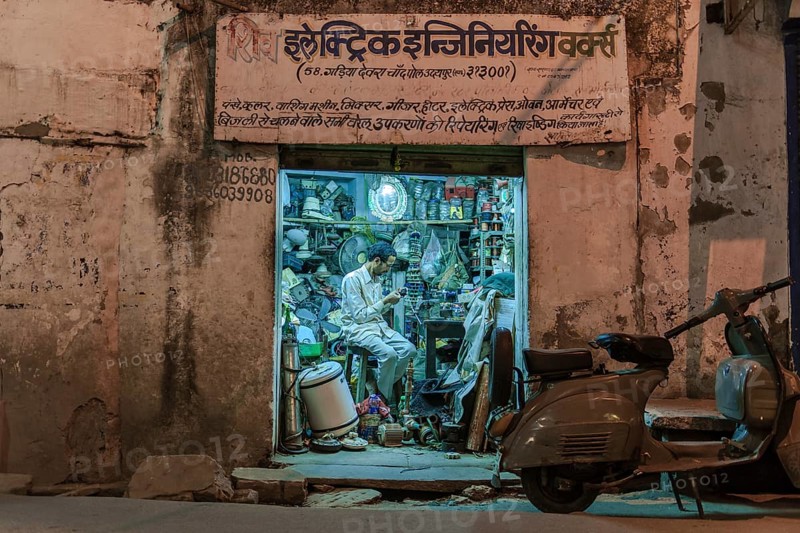 Electronics retailer in his workshop in the evening