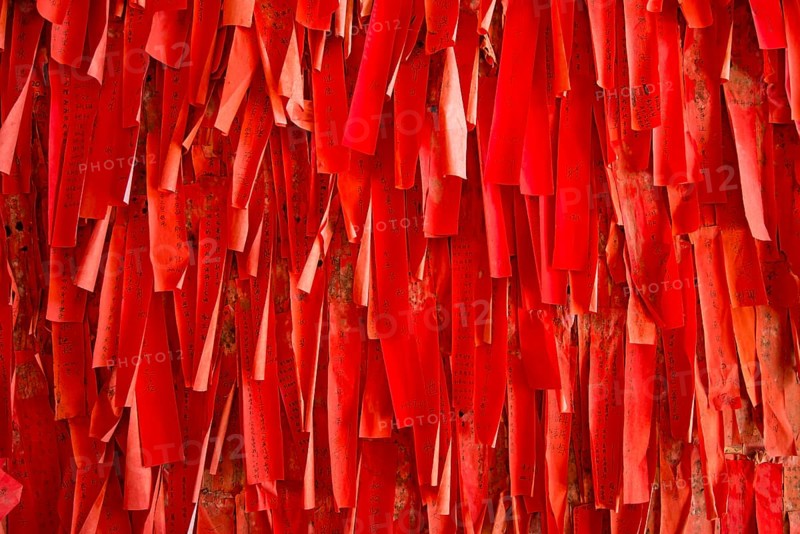 Red luck or wishing papers on a wall in the temple