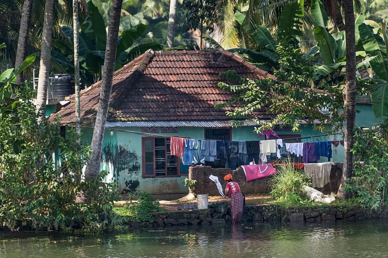 Woman washing laundry in a canal
