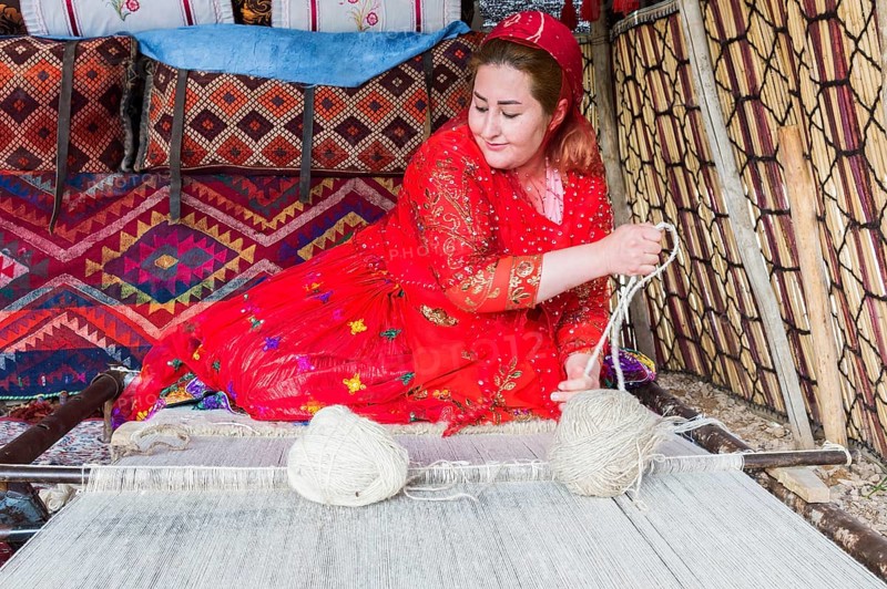 Qashqai woman weaving a carpet