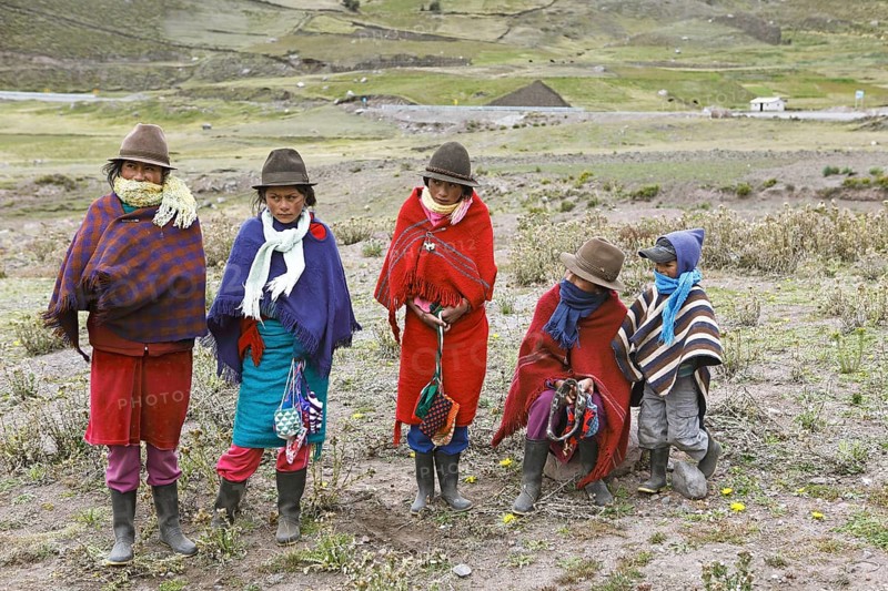 Girls with traditional felt hats offer handmade souvenirs for sale