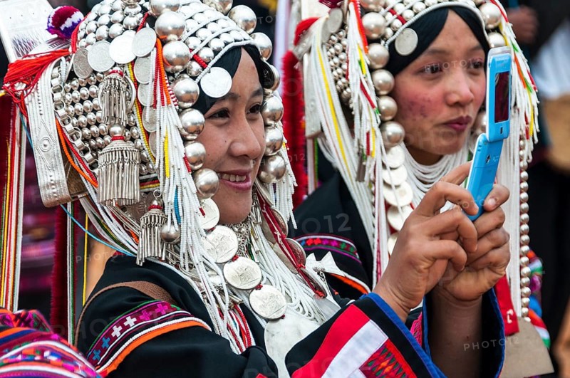 Traditionally dressed smiling young woman from the Akha people
