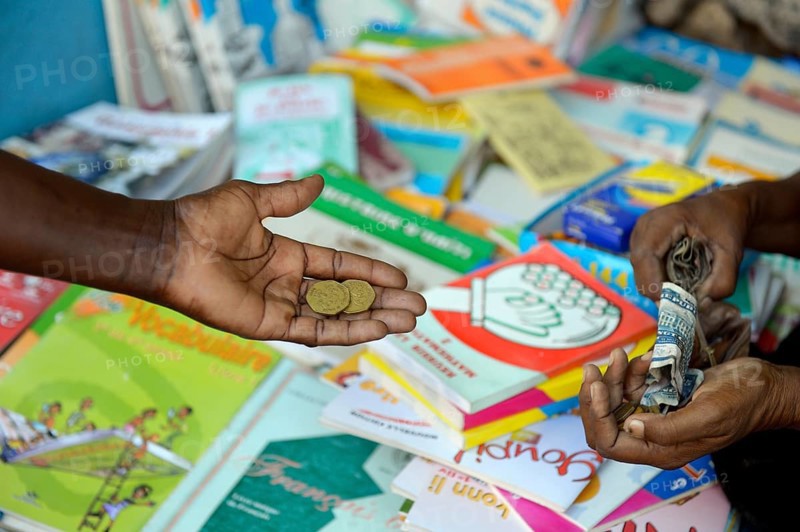 Mother buys school books on the market