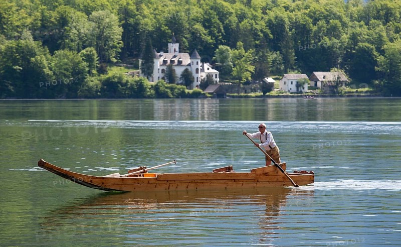 Barge with a rower on Lake Hallstatt or Hallstatter See lake