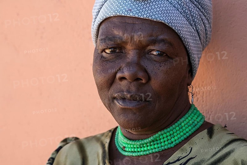 Namibian woman wearing a headscarf and green necklace