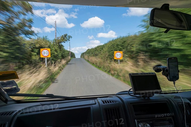 Looking through the front window of a moving camper on the road