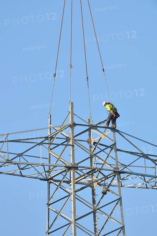 Overhead lineman working on a pylon