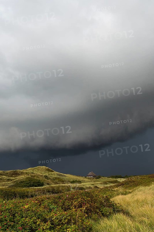Dramatic storm clouds over dunes