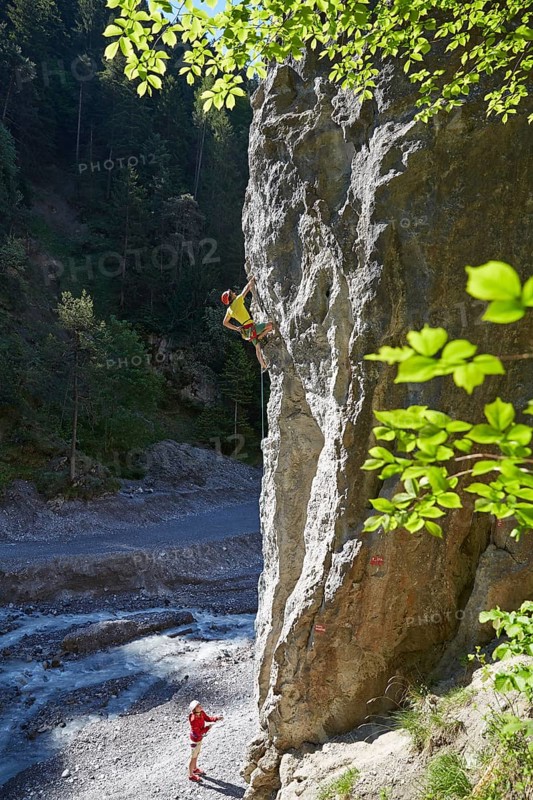 Sport climber climbing a rock face