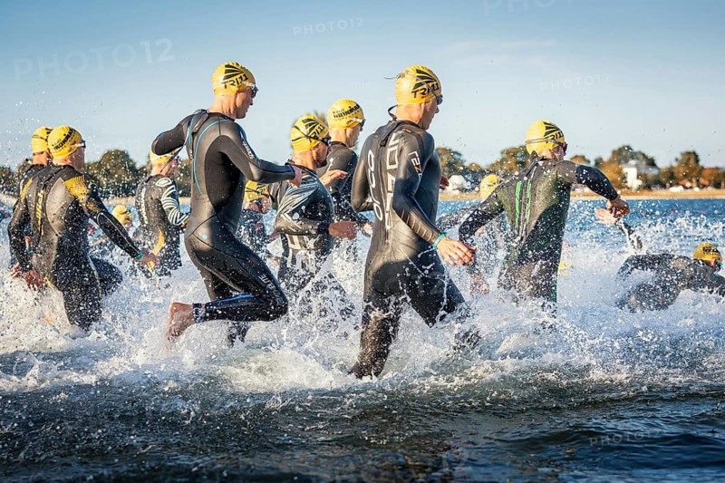 Participants of the Ironman Triathlon starting the race in the surf