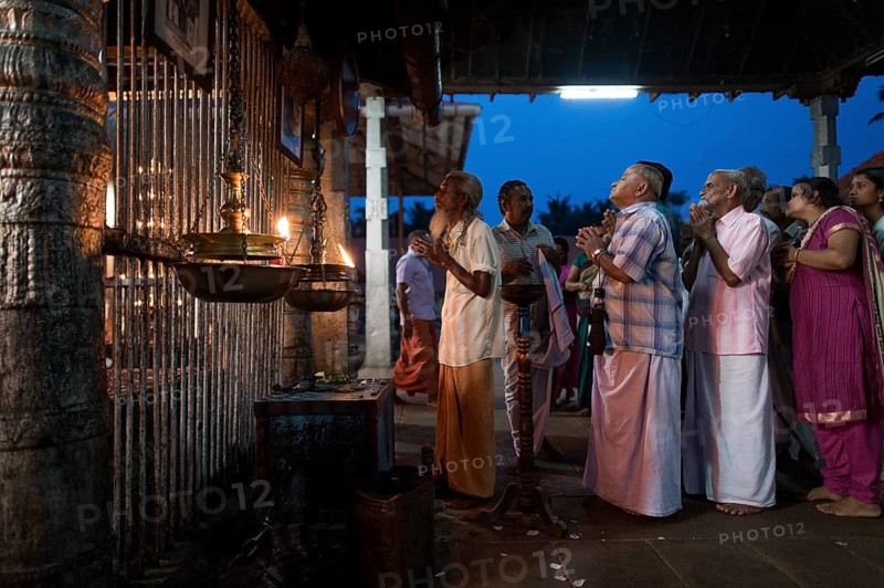 Hindus at evening prayer by the temple