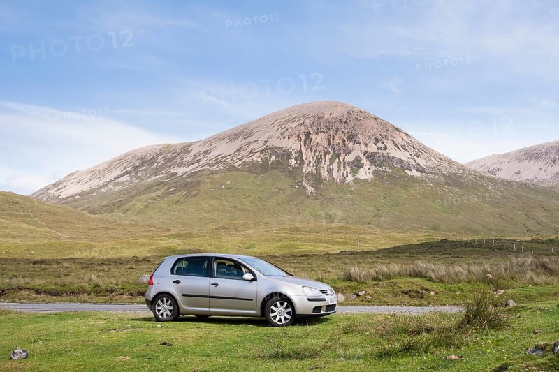 Volkswagen Golf car parked next to road with Beinn Dearg at the back