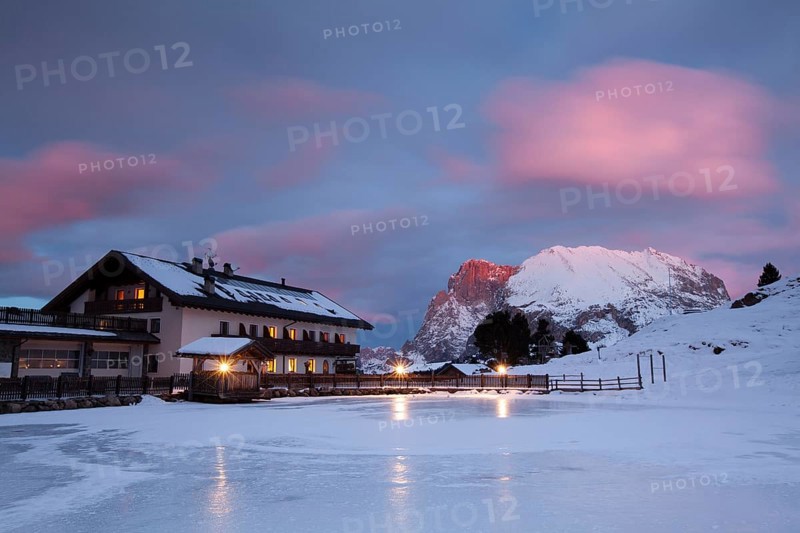 Sunset over Plattkofel and Mahlknechthutte hut in winter