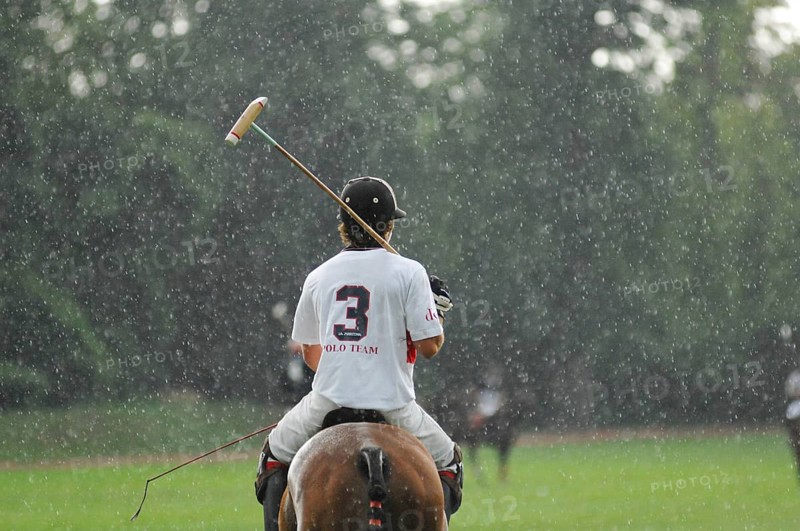Polo players in the rain