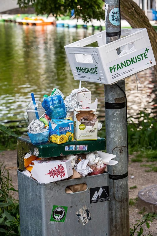 Overflowing public rubbish bin