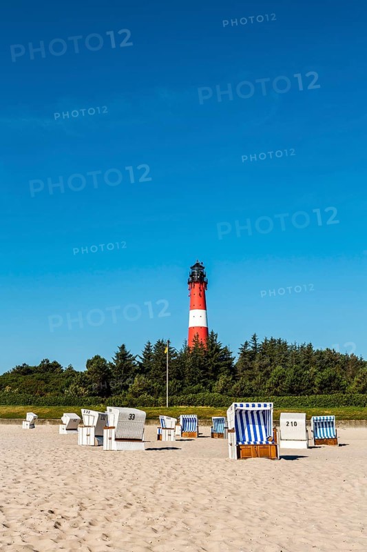 Beach chairs on the beach in front of the lighthouse