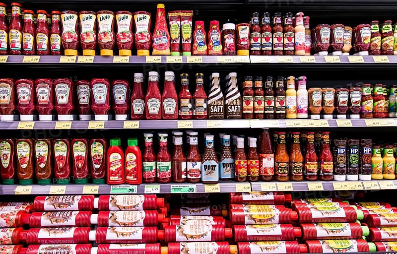 Shelf with various ketchups and sauces
