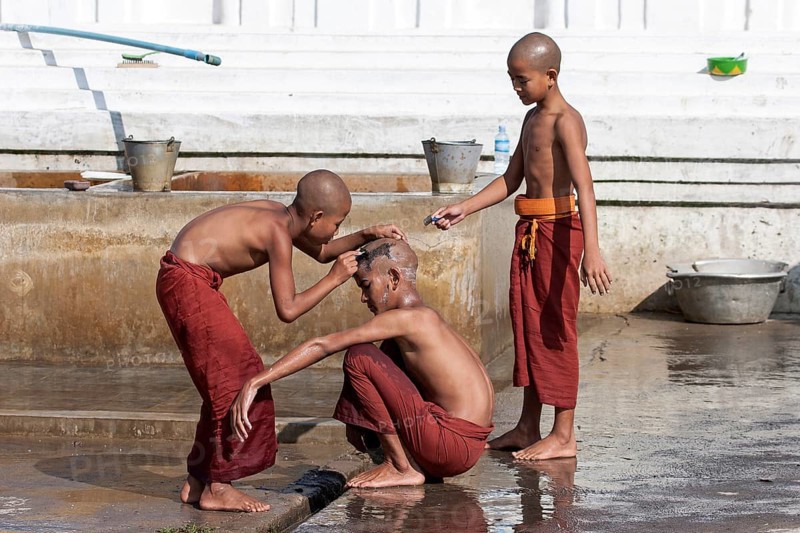 Novice monks during a head shave in the Shwe Yaunghwe Kyaung Monastery