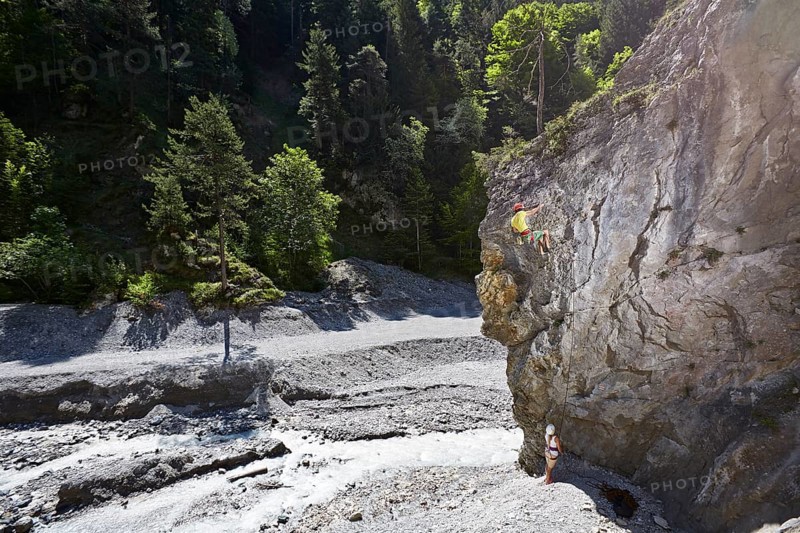 Sport climber climbing a rock face