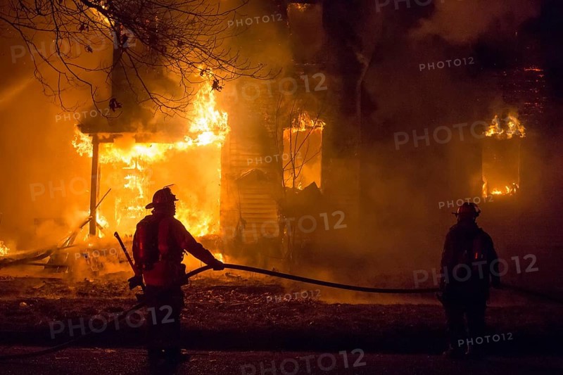 Firefighters battle a fire which destroyed a vacant home in Detroit's Morningside neighborhood