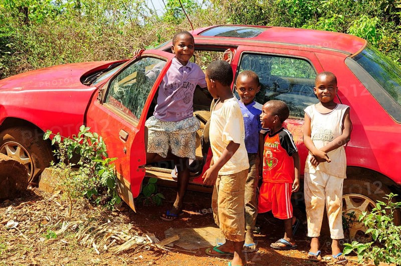 Happy children playing at a car wreck