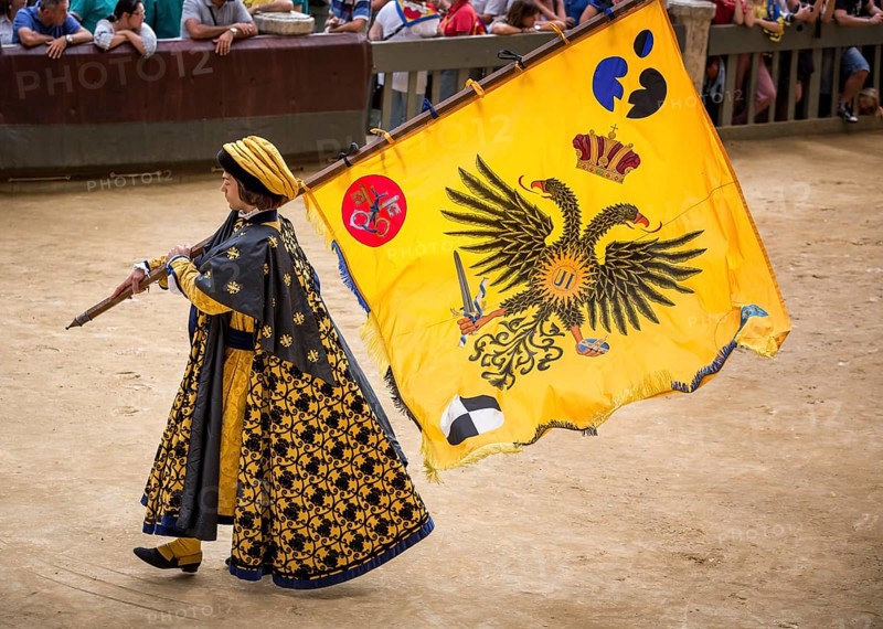 Man carrying a flag from the Eagle or Aquila contrade