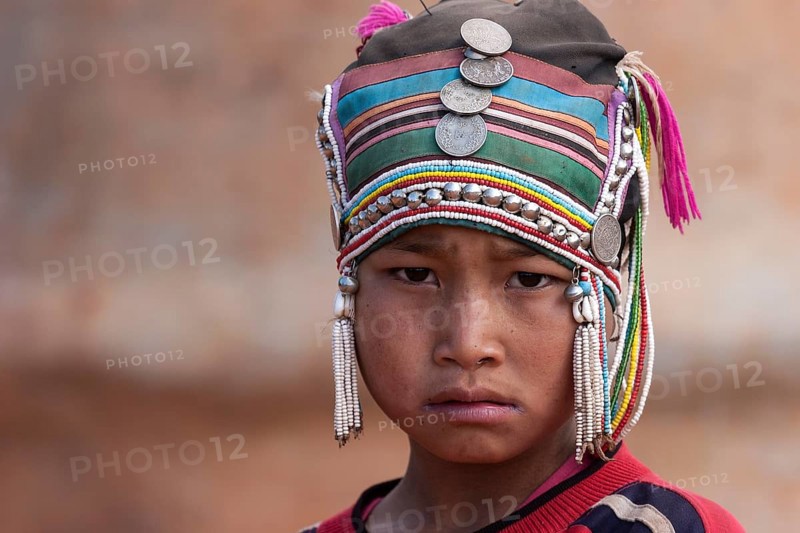 Girl of the Akha ethnic group with traditional headdress