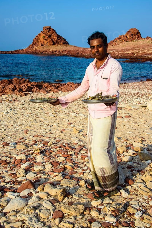 Man presenting fresh shrimps