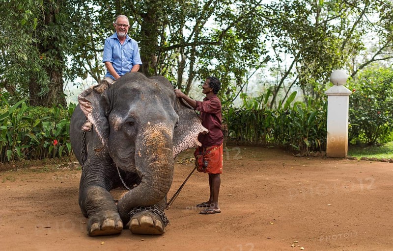 Tourist riding an elephant and mahout or elephant guide