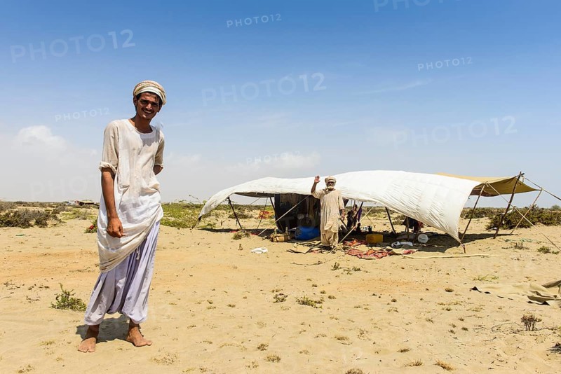 Rashaida man standing in front of his tent in the desert around Massaua