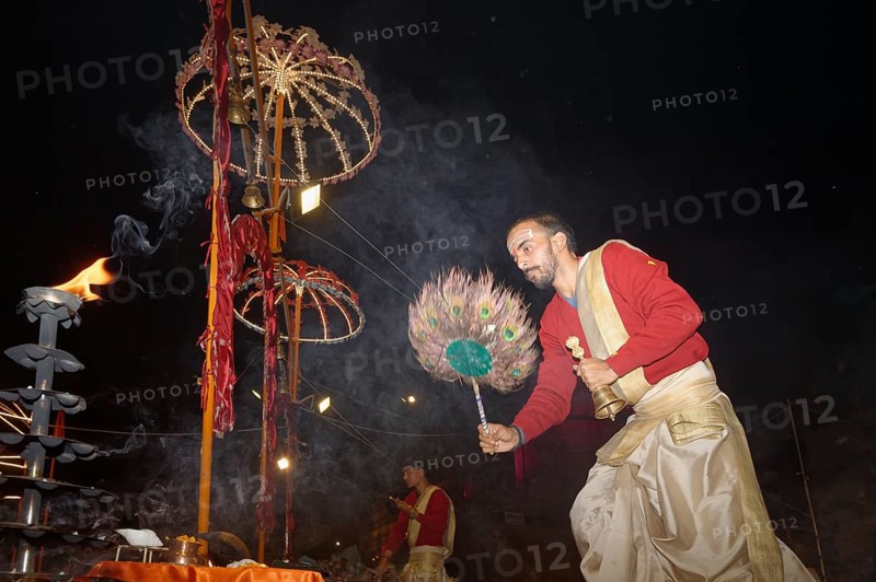 Priest celebrating the Aarti by offering incense