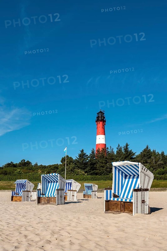 Beach chairs on the beach in front of the lighthouse