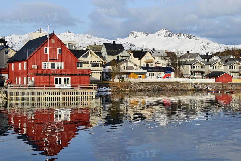 Red house with a private waterfront and several houses in the village