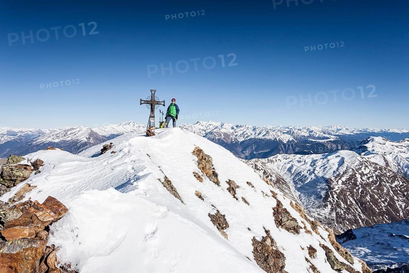 Mountaineer on the summit of Mt Penser Weisshorn