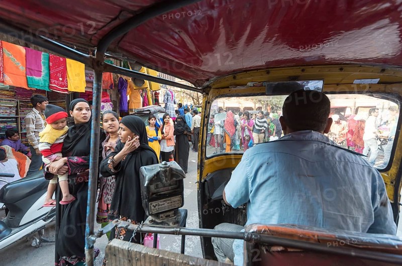 Auto-rickshaw rides through busy street