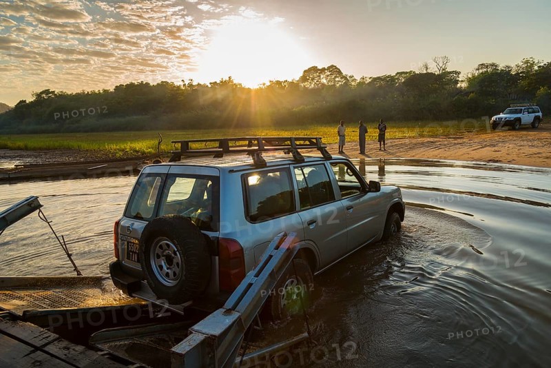 Off-road vehicle driving off the ferry on the Manambolo river